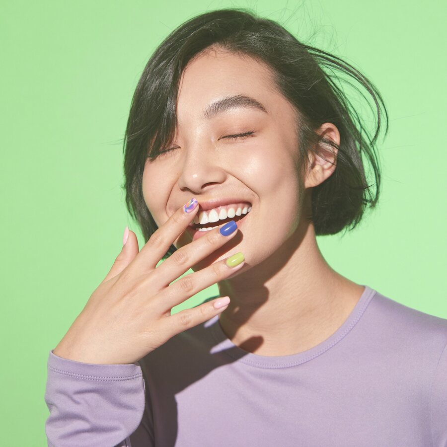 Mei, nail artist with a sleek bob and colourful nails